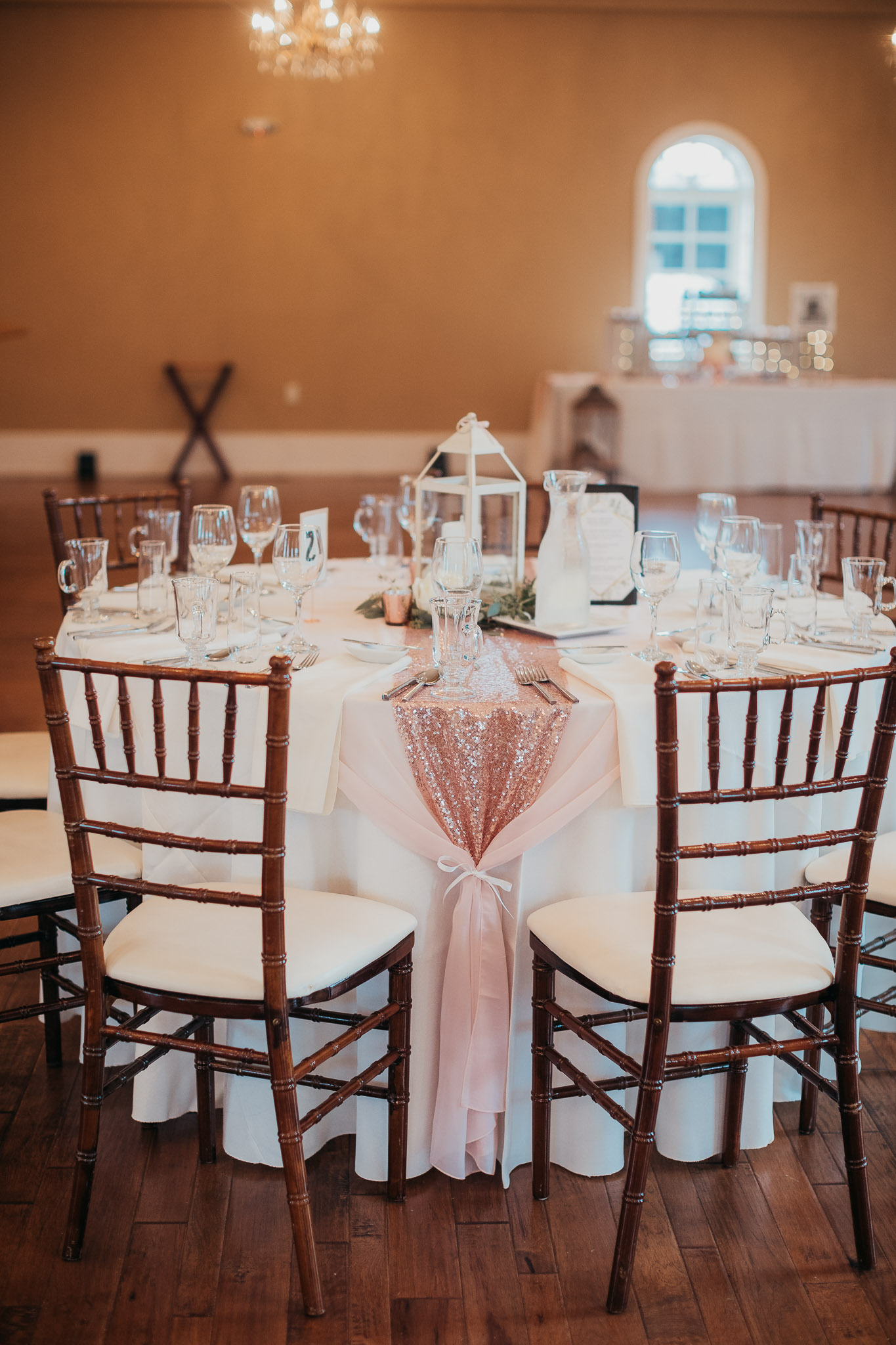 A table set up with chairs and a pink tablecloth.
