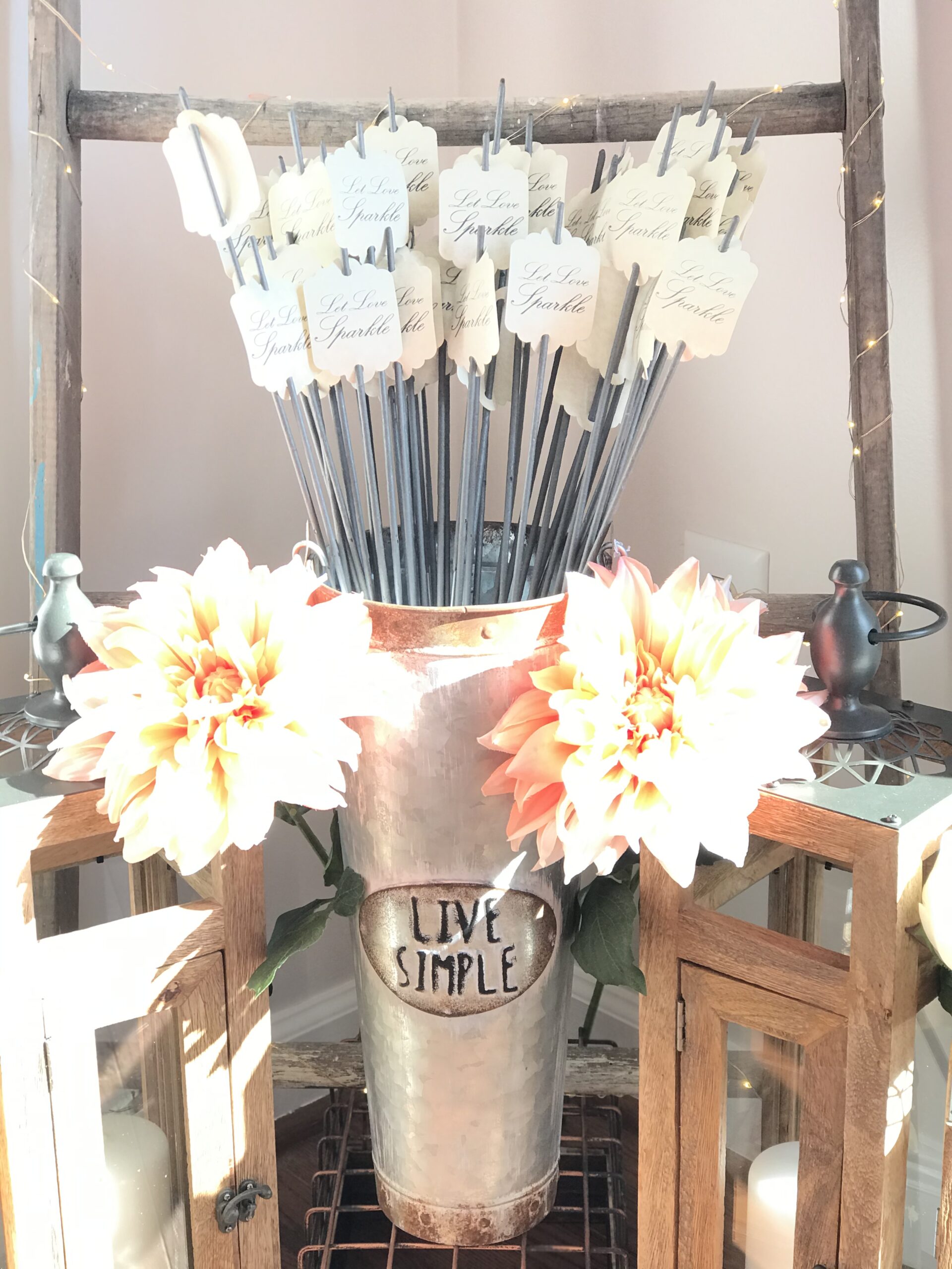 A vase with flowers and some sticks on top of it