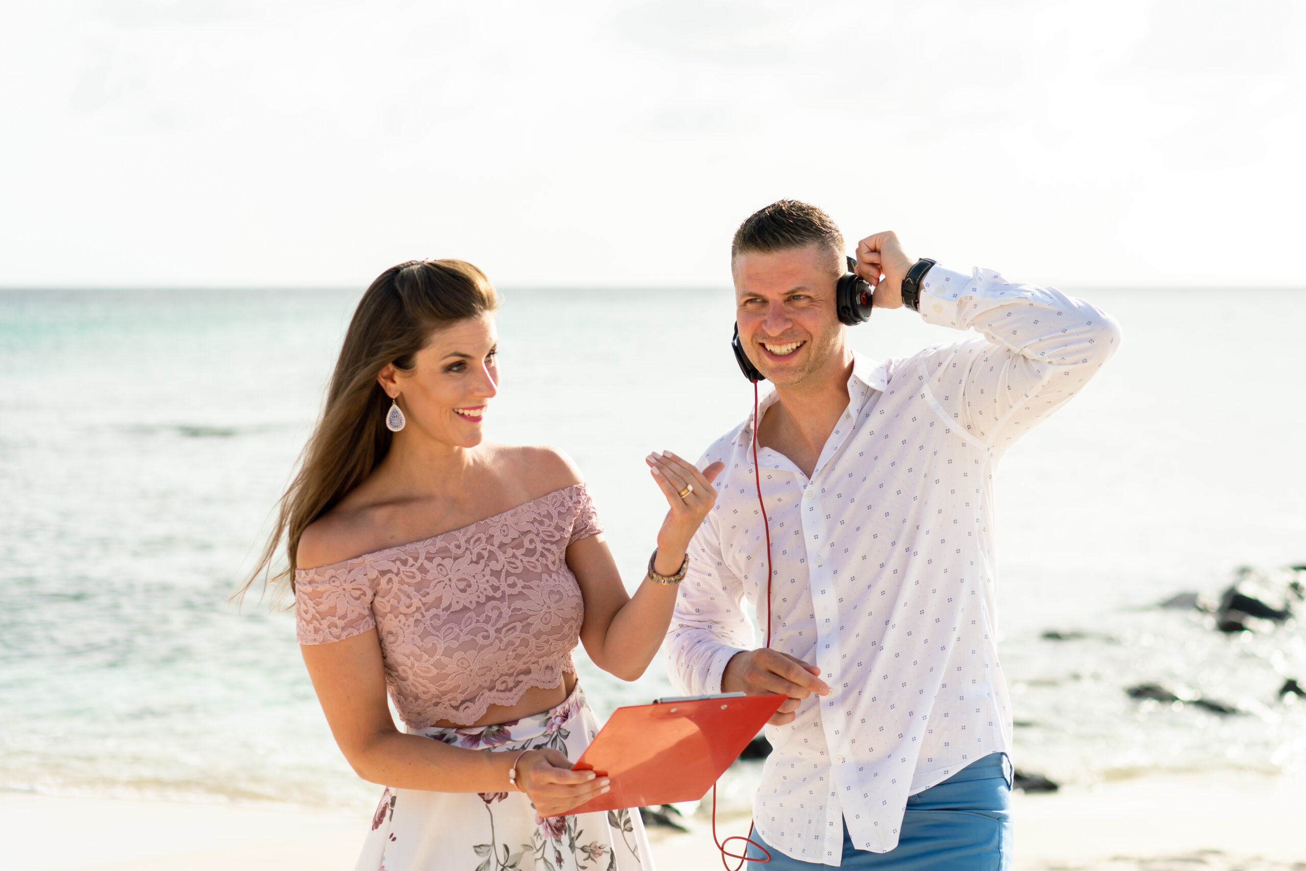 A man and woman standing on the beach