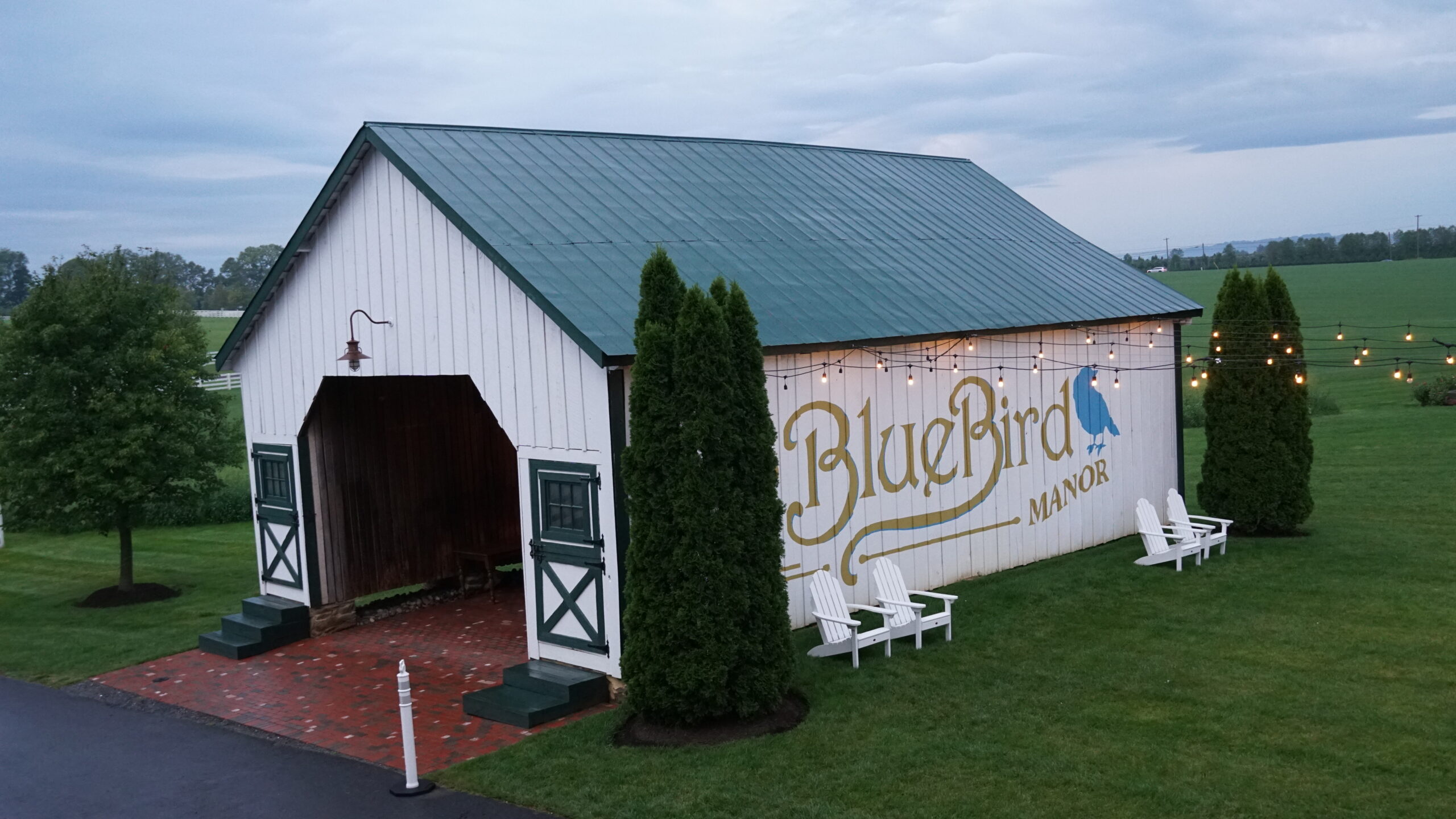 A barn with a blue bird sign painted on it.